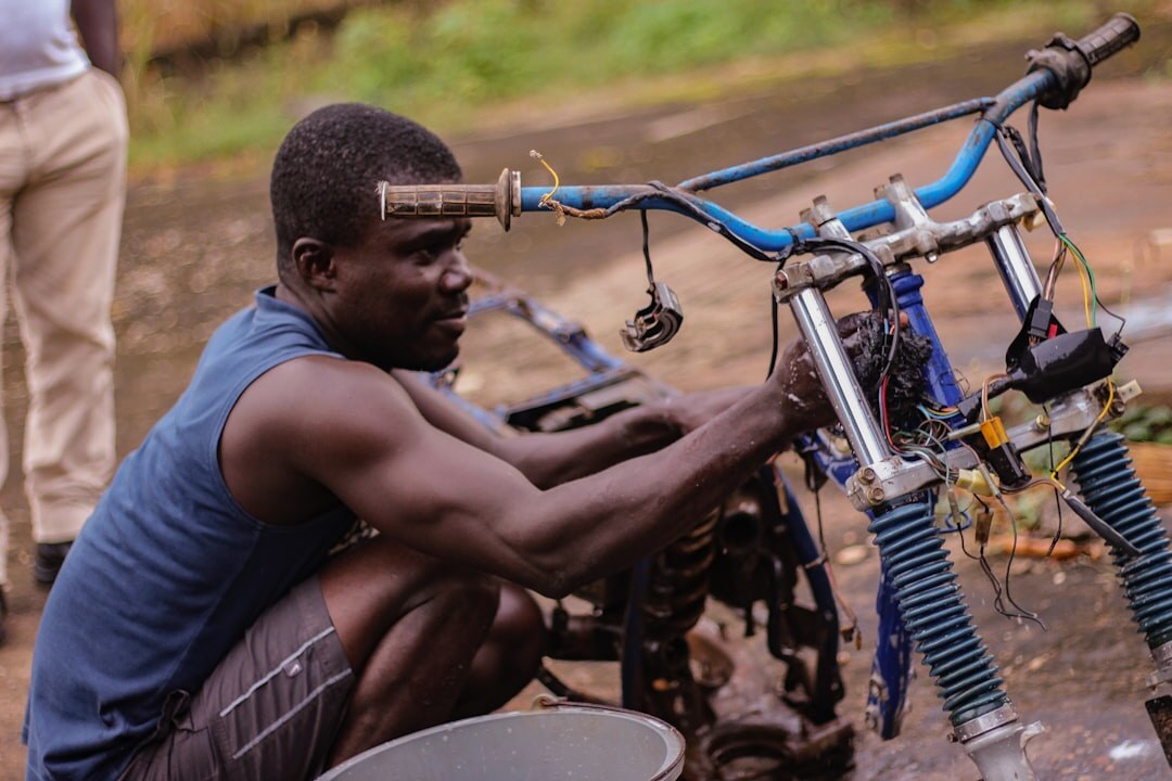 young mechanic fixing bike