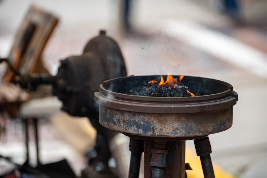 elderly blacksmith at forge